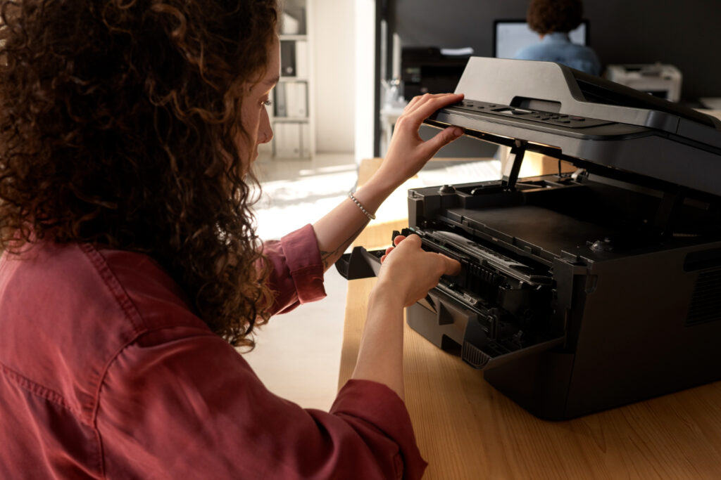 Woman is checking printer waste container
